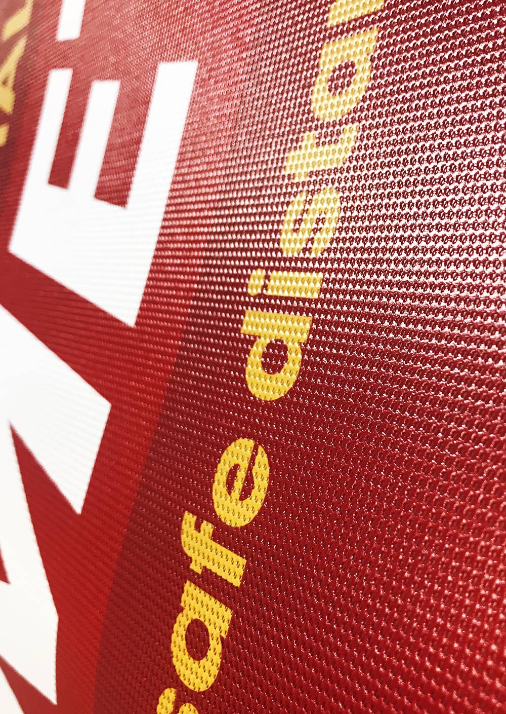 COVID-Social-distancing-mesh-banners-for-Liverpool-FC-close-up Liverpool FC Social Distancing COVID Correx Print